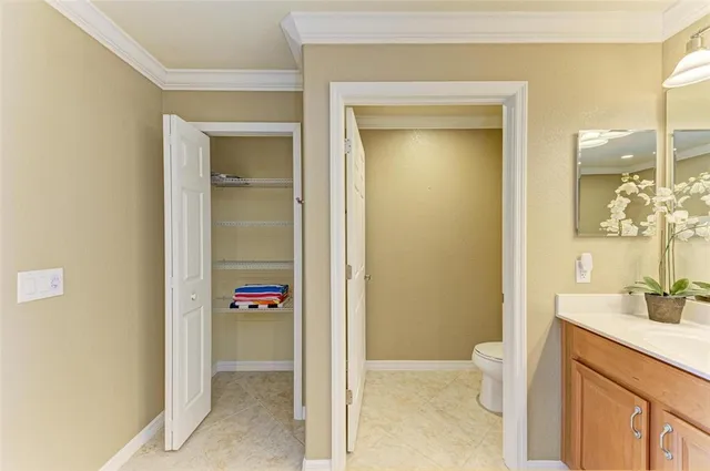 a kitchen with stainless steel appliances kitchen island granite countertop a sink and a refrigerator