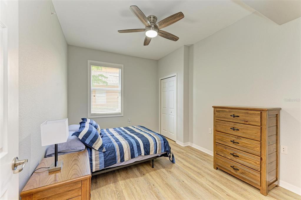 424 Winding Brook Lane, Unit 104 Bradenton, FL 34212 - Photo 24 of 72 a bedroom with a bed and a dresser
