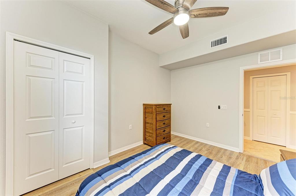 424 Winding Brook Lane, Unit 104 Bradenton, FL 34212 - Photo 25 of 72 a bedroom with wooden floor closet and ceiling fan