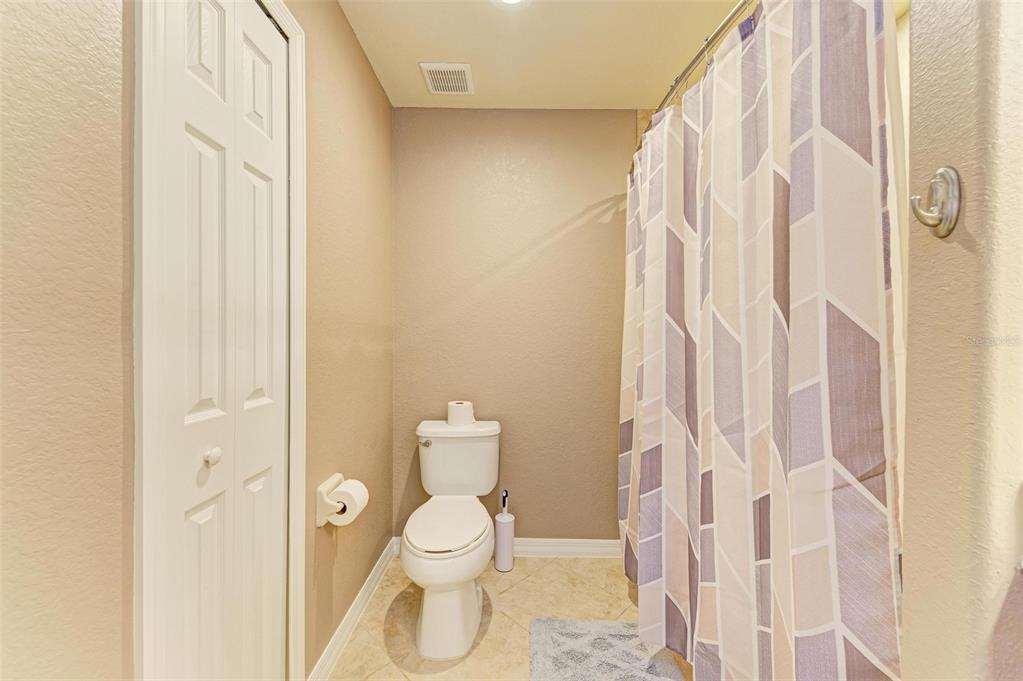 424 Winding Brook Lane, Unit 104 Bradenton, FL 34212 - Photo 27 of 72 a bathroom with a toilet and shower curtain