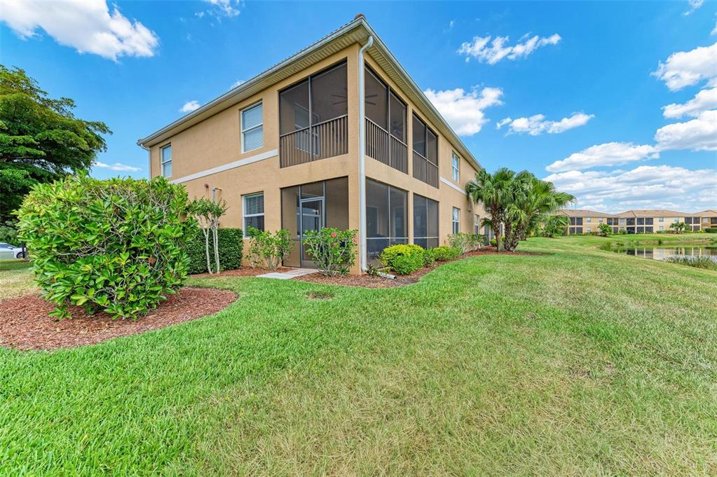 424 Winding Brook Lane, Unit 104 Bradenton, FL 34212 - Photo 35 of 72 a front view of a house with garden