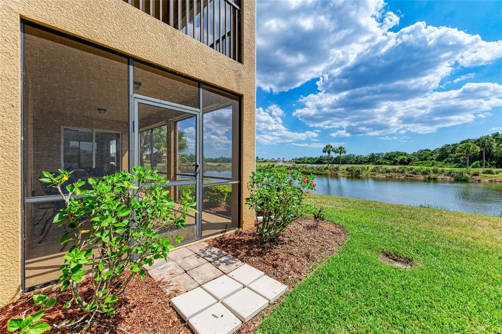 424 Winding Brook Lane, Unit 104 Bradenton, FL 34212 - Photo 4 of 72 a view of a garden with a bench in balcony