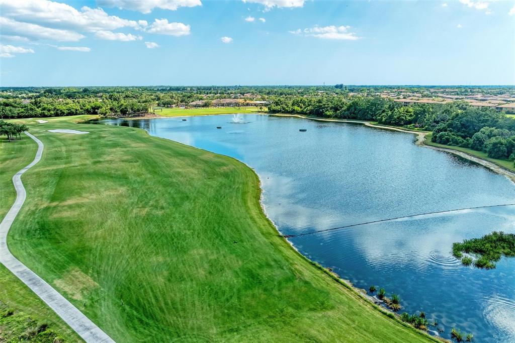 424 Winding Brook Lane, Unit 104 Bradenton, FL 34212 - Photo 51 of 72 a view of a lake with a big yard