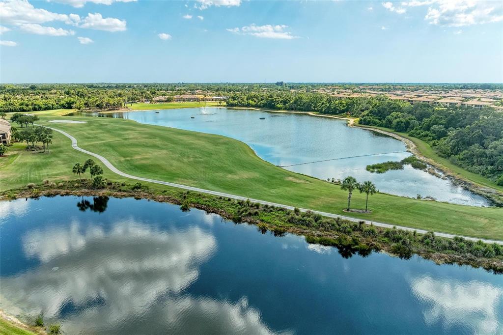 424 Winding Brook Lane, Unit 104 Bradenton, FL 34212 - Photo 54 of 72 a view of a lake with a city