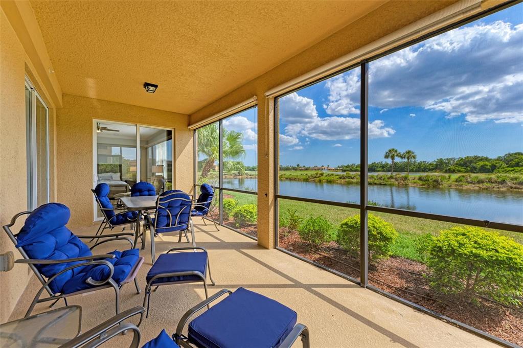 424 Winding Brook Lane, Unit 104 Bradenton, FL 34212 - Photo 6 of 72 a living room with patio area view and a potted plant