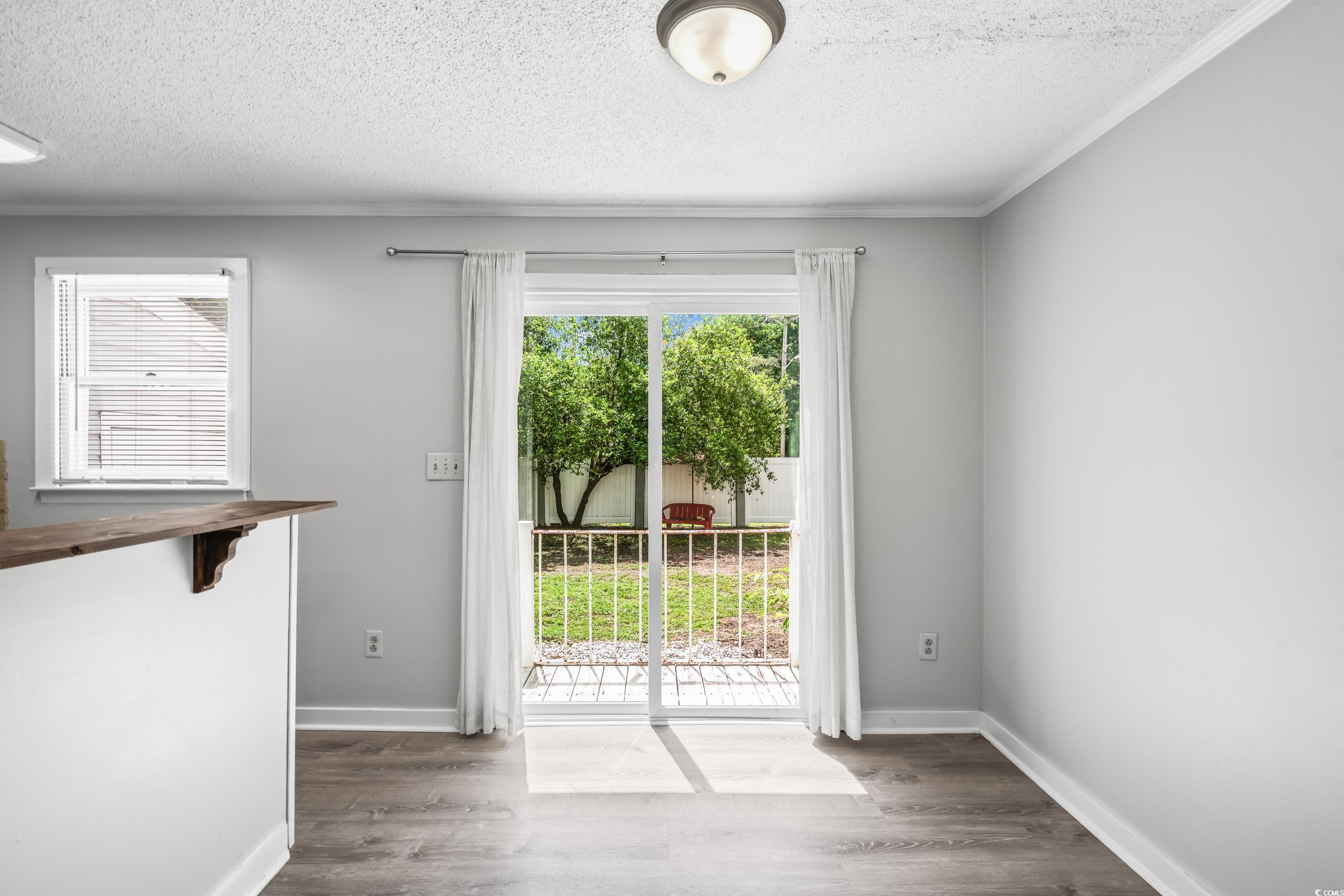 4115 Little River Road, Unit 1E Myrtle Beach, SC 29577 - Photo 8 of 38 Entryway with a textured ceiling, wood finished floors, and ornamental molding
