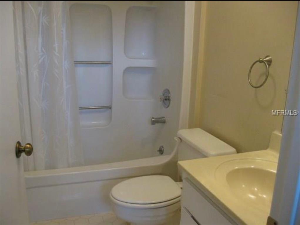11450 Harbor Way, Unit 5002 Largo, FL 33774 - Photo 14 of 25 a bathroom with a toilet and a shower