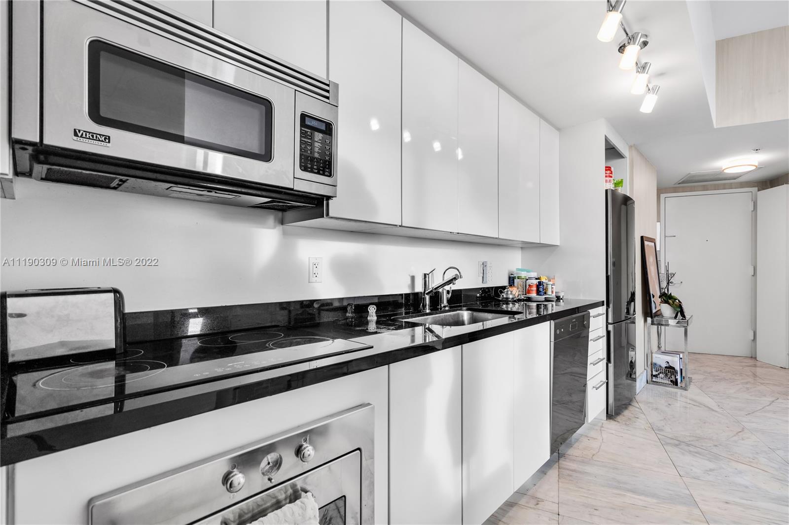 92 Southwest 3rd Street, Unit 5106 Miami, FL 33130 - Photo 13 of 36 a kitchen with stainless steel appliances a sink dishwasher a stove microwave and cabinets