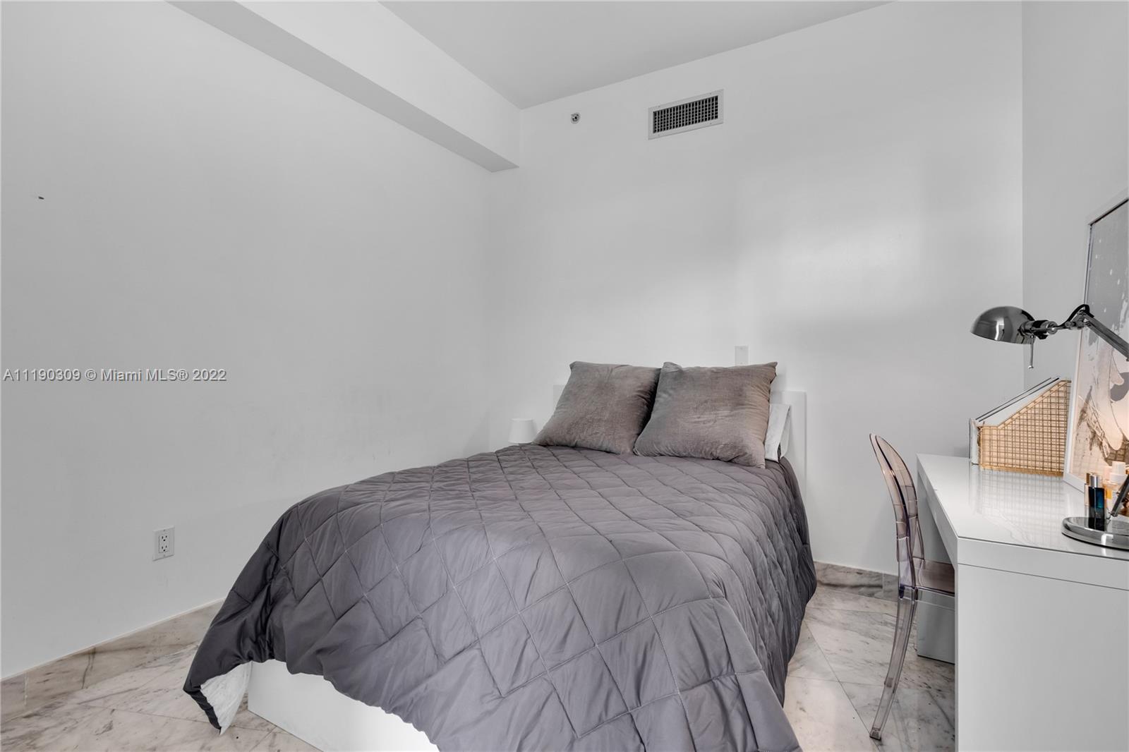 92 Southwest 3rd Street, Unit 5106 Miami, FL 33130 - Photo 16 of 36 a large bed sitting in a bedroom next to a window