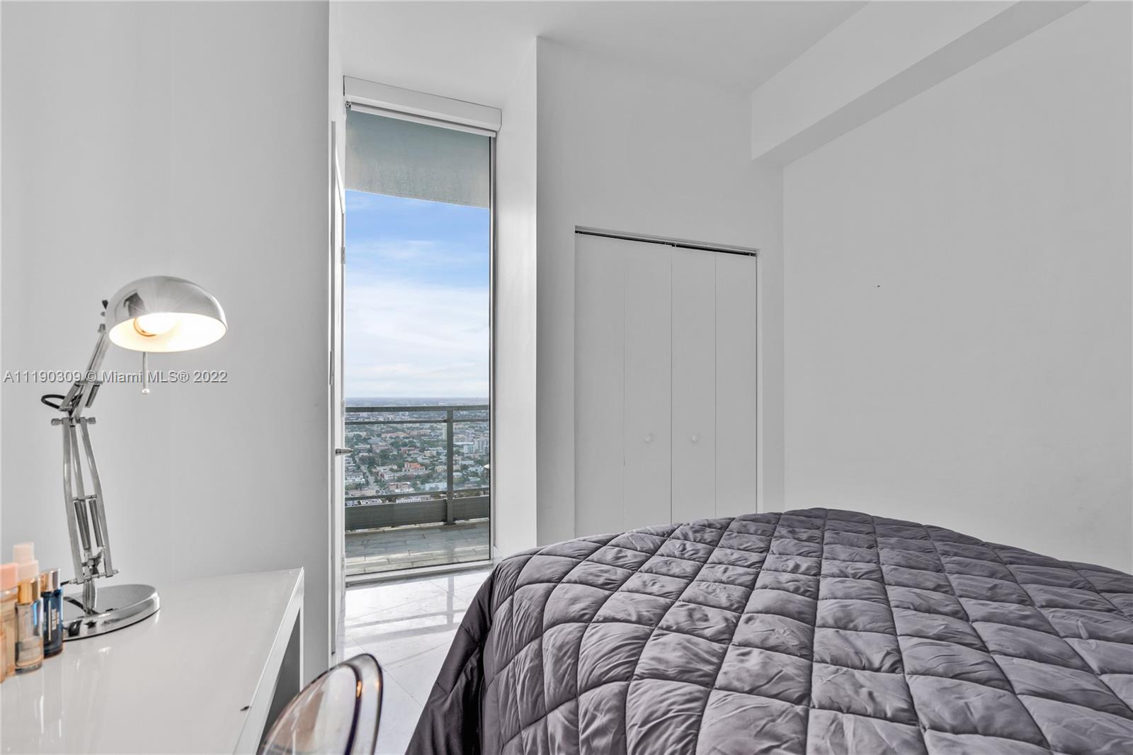 92 Southwest 3rd Street, Unit 5106 Miami, FL 33130 - Photo 17 of 36 a bedroom with a bed and a window