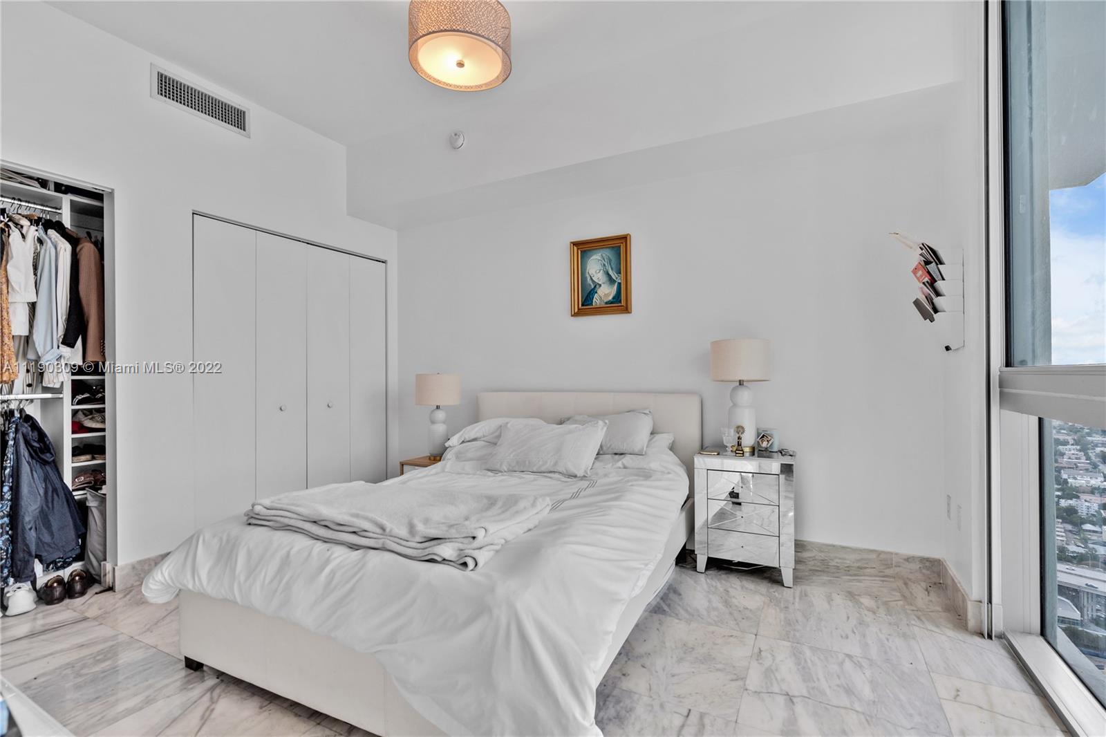92 Southwest 3rd Street, Unit 5106 Miami, FL 33130 - Photo 19 of 36 a spacious bedroom with a bed and a window