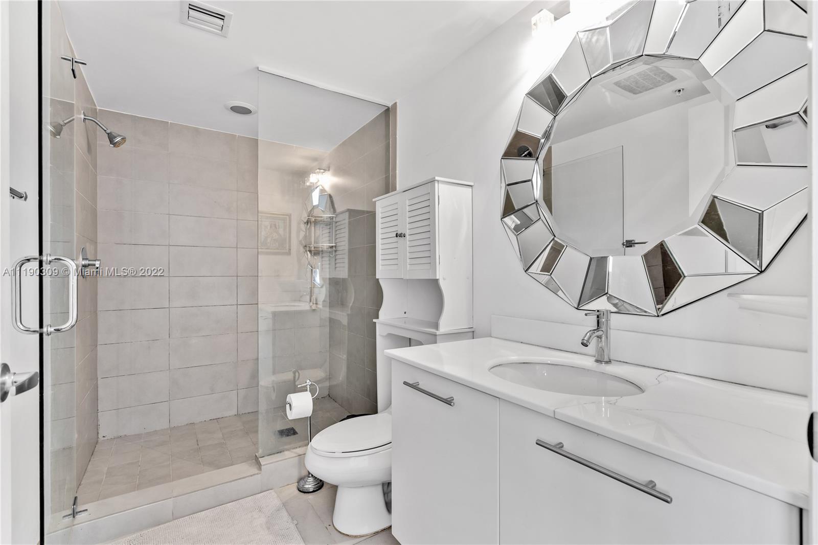 92 Southwest 3rd Street, Unit 5106 Miami, FL 33130 - Photo 22 of 36 a bathroom with a sink a toilet and shower