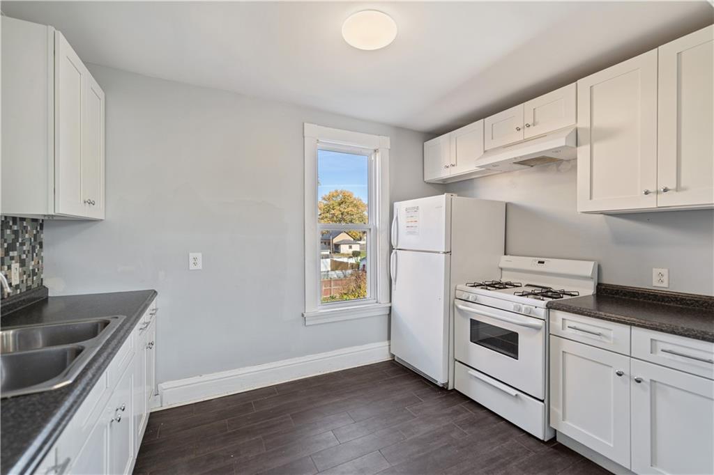 726 Market Street, Unit 3 Beaver, PA 15009 - Photo 6 of 24 a kitchen with granite countertop white cabinets and white appliances