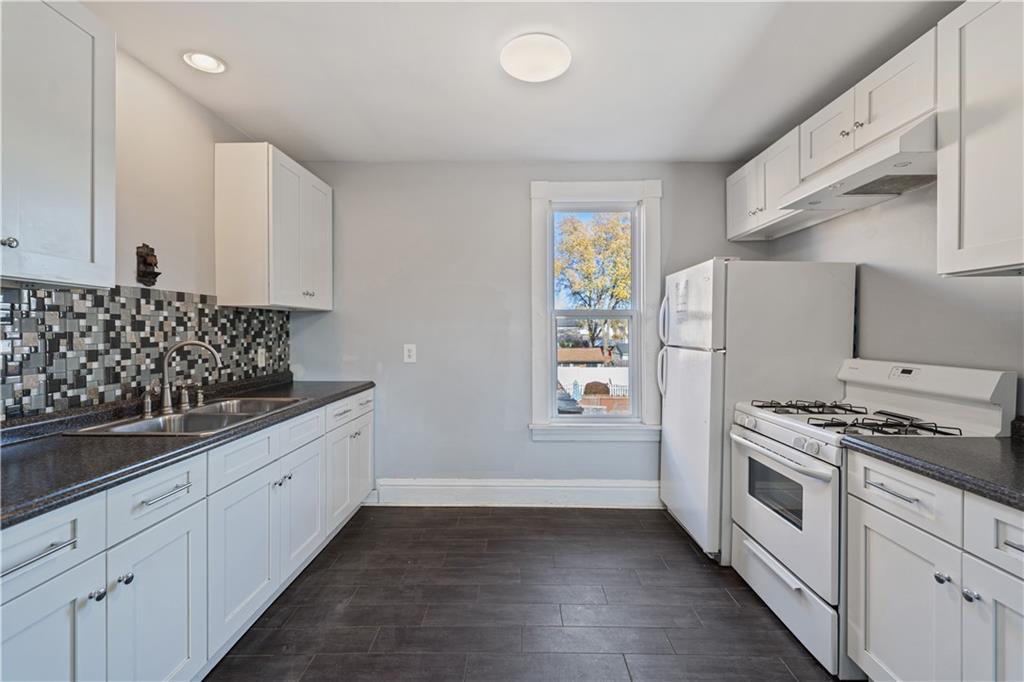 726 Market Street, Unit 3 Beaver, PA 15009 - Photo 8 of 24 a kitchen with granite countertop a sink and a stove top oven