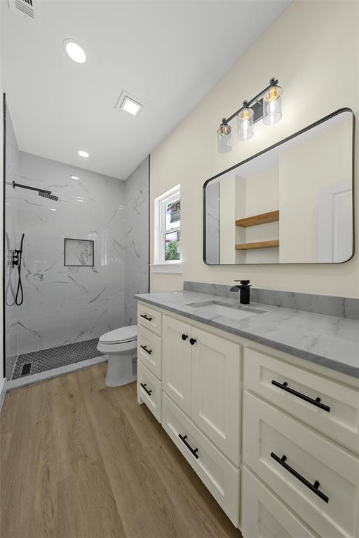 3320 North 27th Street Waco, TX 76708 - Photo 24 of 38 a spacious bathroom with a double vanity sink a mirror and a toilet