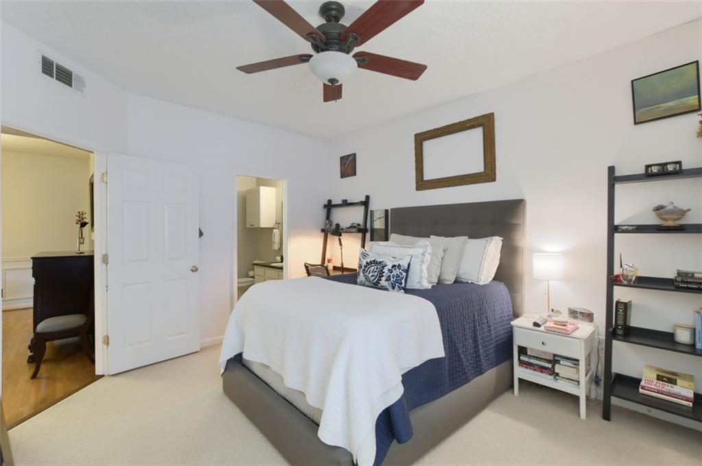 955 Juniper Street Northeast, Unit 4324 Atlanta, GA 30309 - Photo 13 of 26 a bedroom with a bed and a chandelier