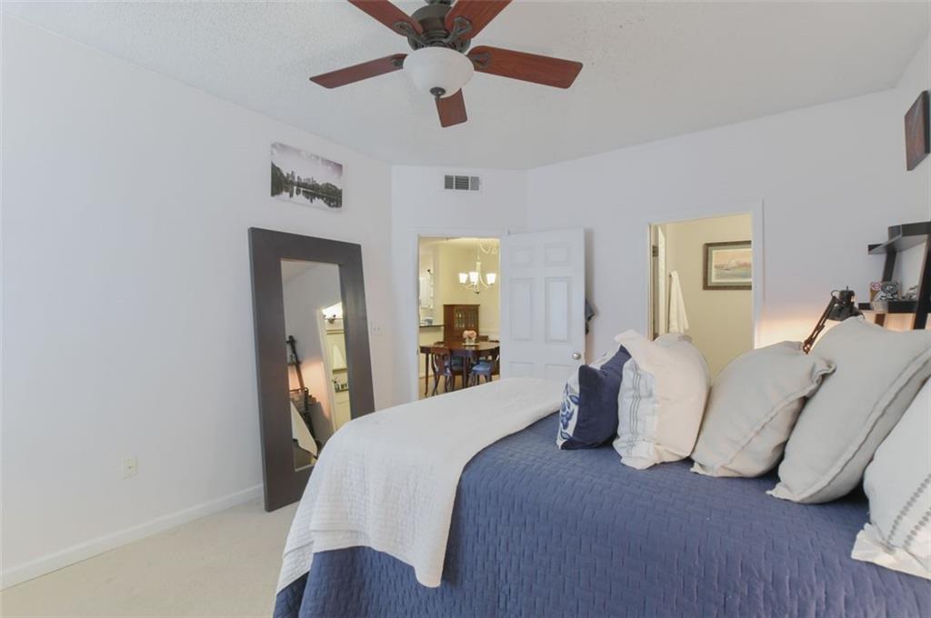955 Juniper Street Northeast, Unit 4324 Atlanta, GA 30309 - Photo 14 of 26 a bedroom with bed and ceiling fan