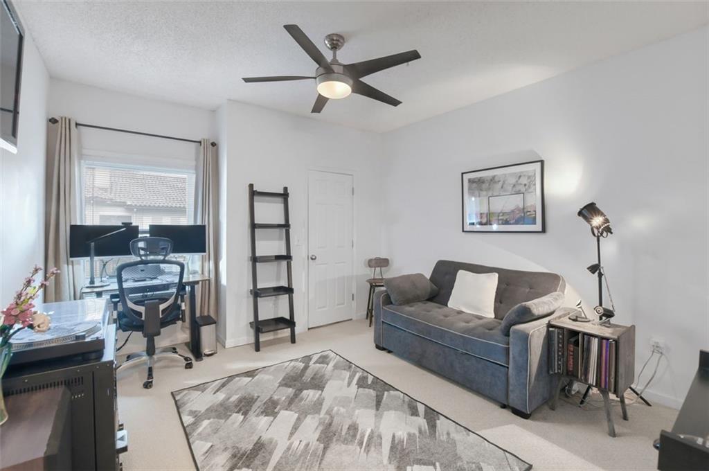955 Juniper Street Northeast, Unit 4324 Atlanta, GA 30309 - Photo 15 of 26 a living room with furniture and two window