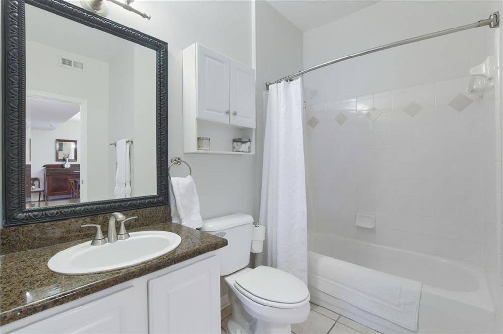 955 Juniper Street Northeast, Unit 4324 Atlanta, GA 30309 - Photo 17 of 26 a bathroom with a granite countertop sink toilet and shower