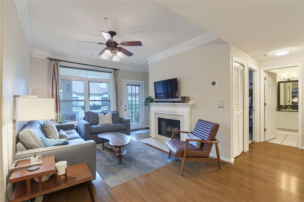 955 Juniper Street Northeast, Unit 4324 Atlanta, GA 30309 - Photo 3 of 26 a living room with furniture a fireplace and a chandelier