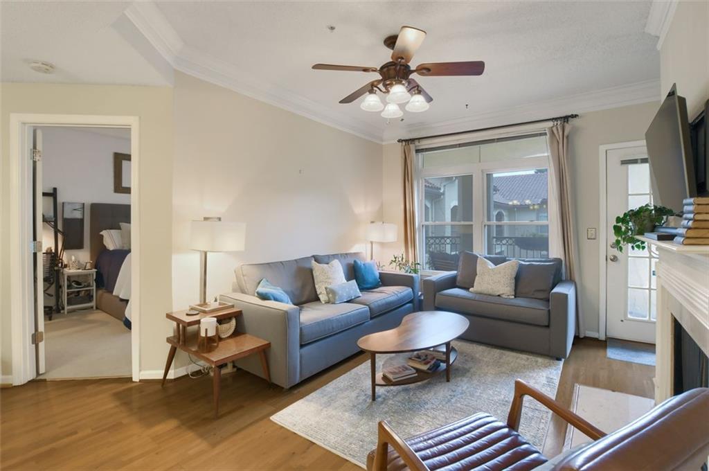 955 Juniper Street Northeast, Unit 4324 Atlanta, GA 30309 - Photo 4 of 26 a living room with furniture a chandelier and a table