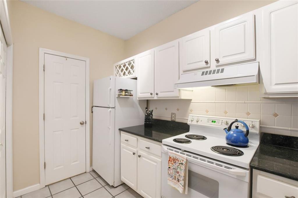 955 Juniper Street Northeast, Unit 4324 Atlanta, GA 30309 - Photo 8 of 26 a kitchen with white cabinets and appliances