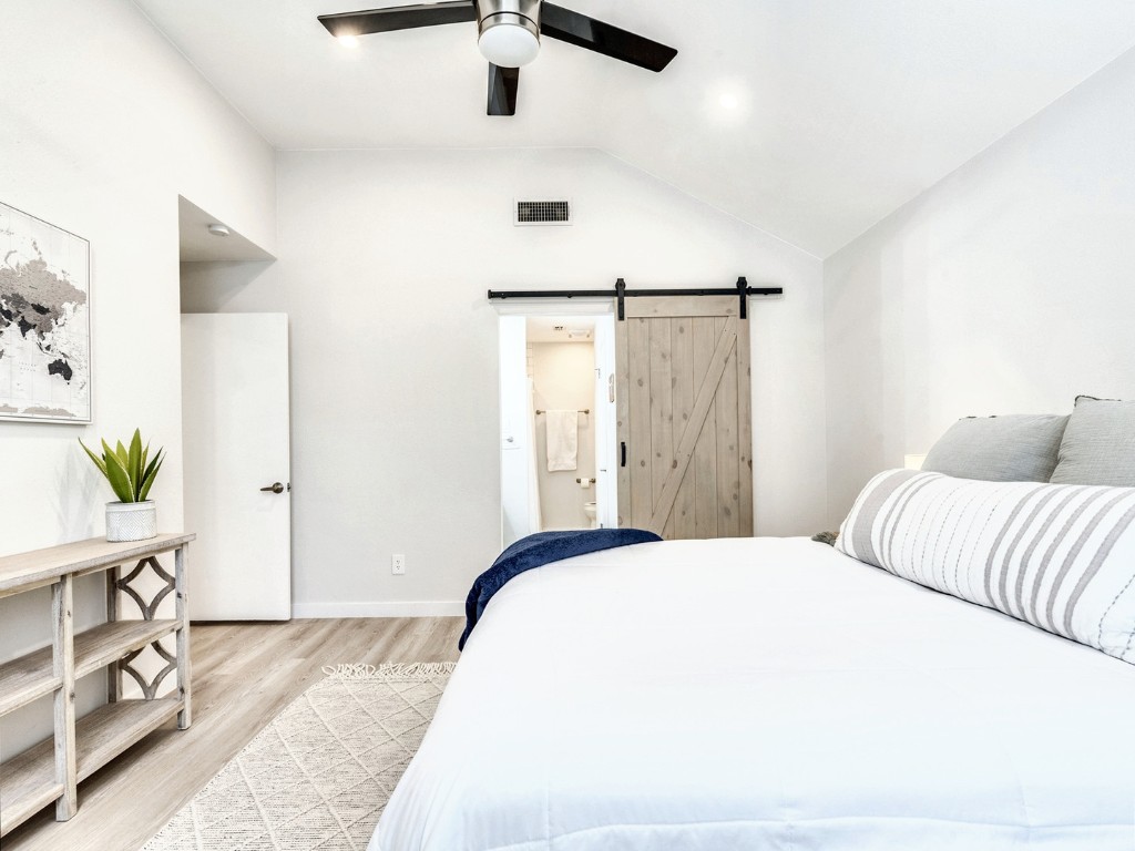 14205 Vandever Street Austin, TX 78725 - Photo 12 of 23 a bedroom with a bed and a dresser