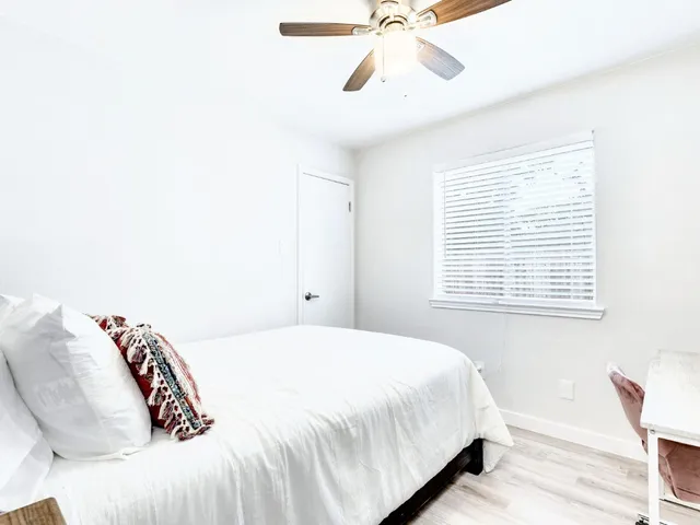 a bedroom with a bed and a window