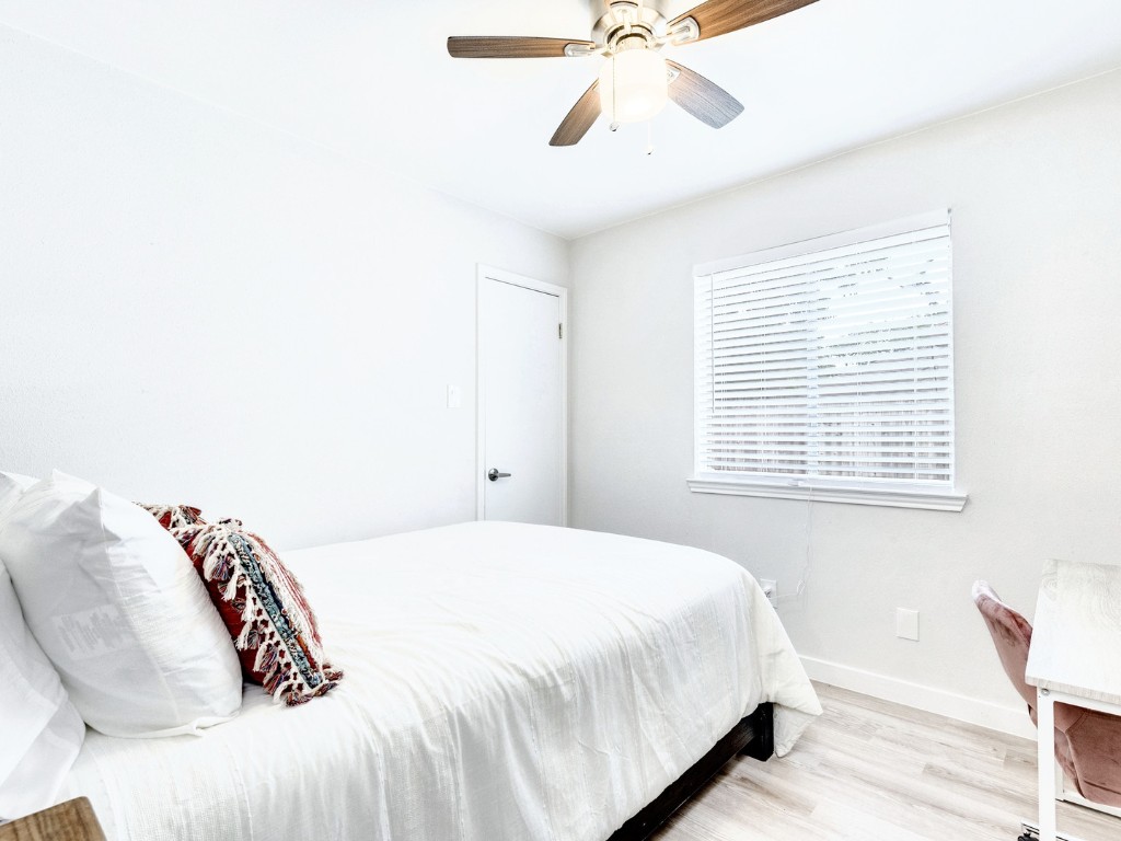 14205 Vandever Street Austin, TX 78725 - Photo 14 of 23 a bedroom with a bed and a window
