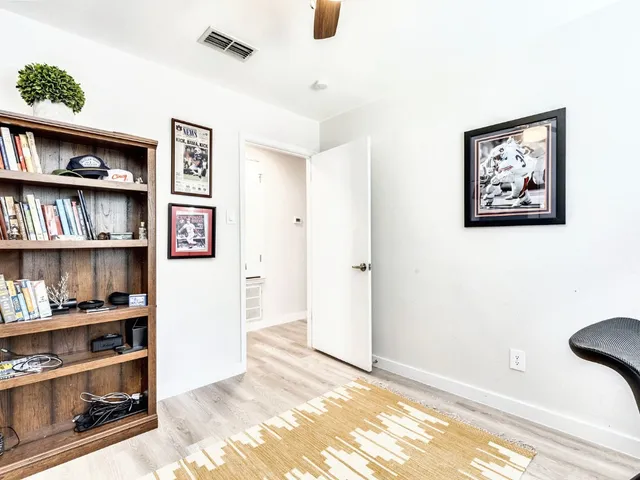 a view of a bedroom with cabinet and wall painting