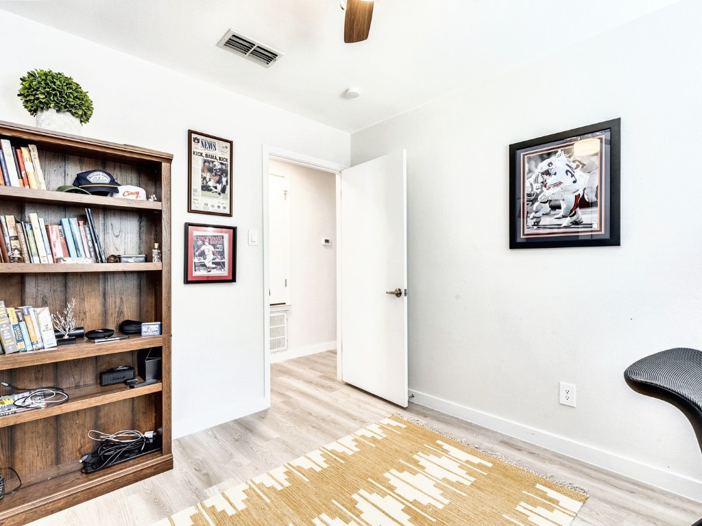 14205 Vandever Street Austin, TX 78725 - Photo 17 of 23 a view of a bedroom with cabinet and wall painting