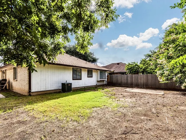 a front view of house with yard and trees
