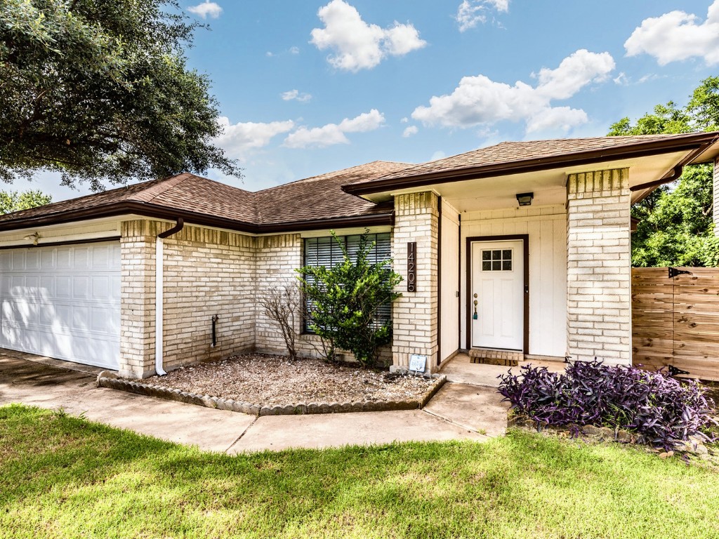 14205 Vandever Street Austin, TX 78725 - Photo 3 of 23 a view of a house with backyard and garden