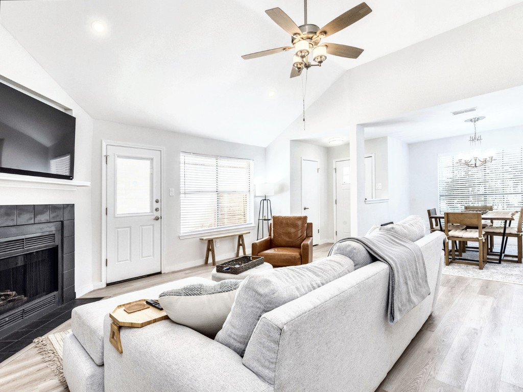 14205 Vandever Street Austin, TX 78725 - Photo 6 of 23 a living room with furniture a fireplace and a flat screen tv