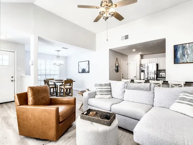 a living room with furniture and a chandelier