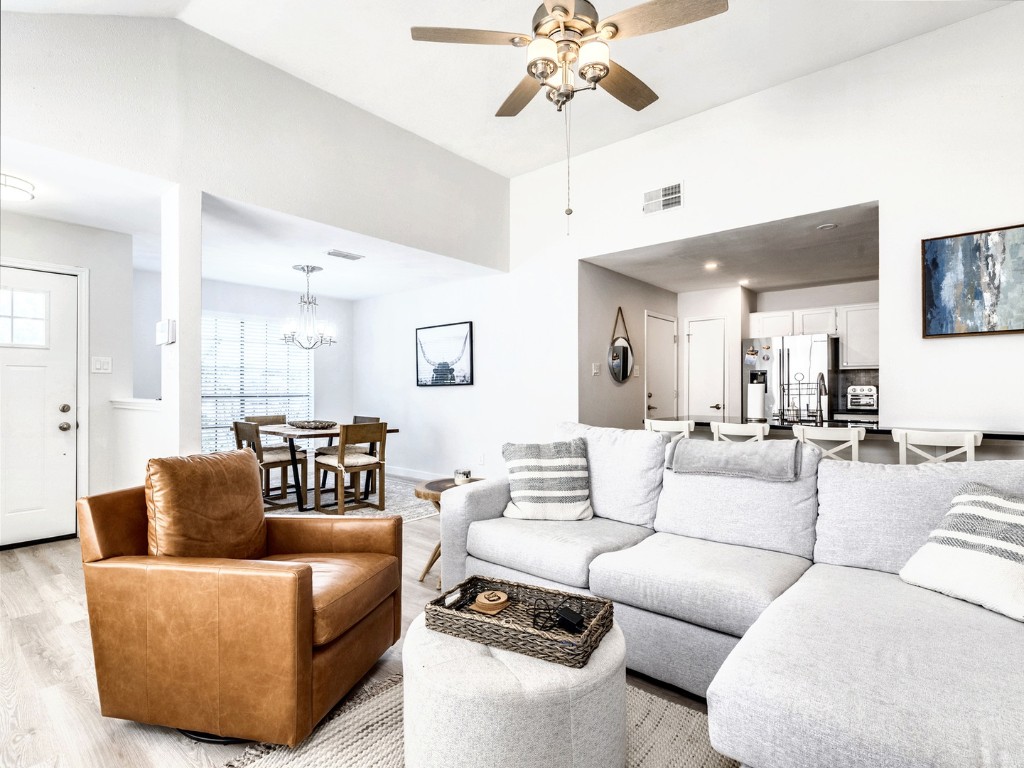 14205 Vandever Street Austin, TX 78725 - Photo 7 of 23 a living room with furniture and a chandelier