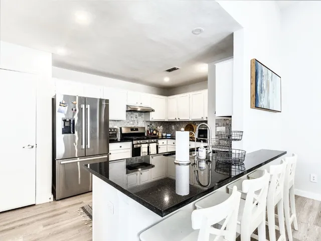a kitchen with refrigerator and cabinets