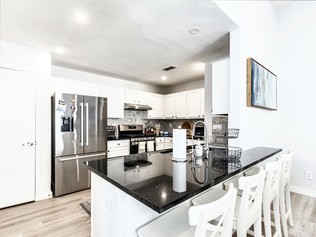 14205 Vandever Street Austin, TX 78725 - Photo 9 of 23 a kitchen with refrigerator and cabinets