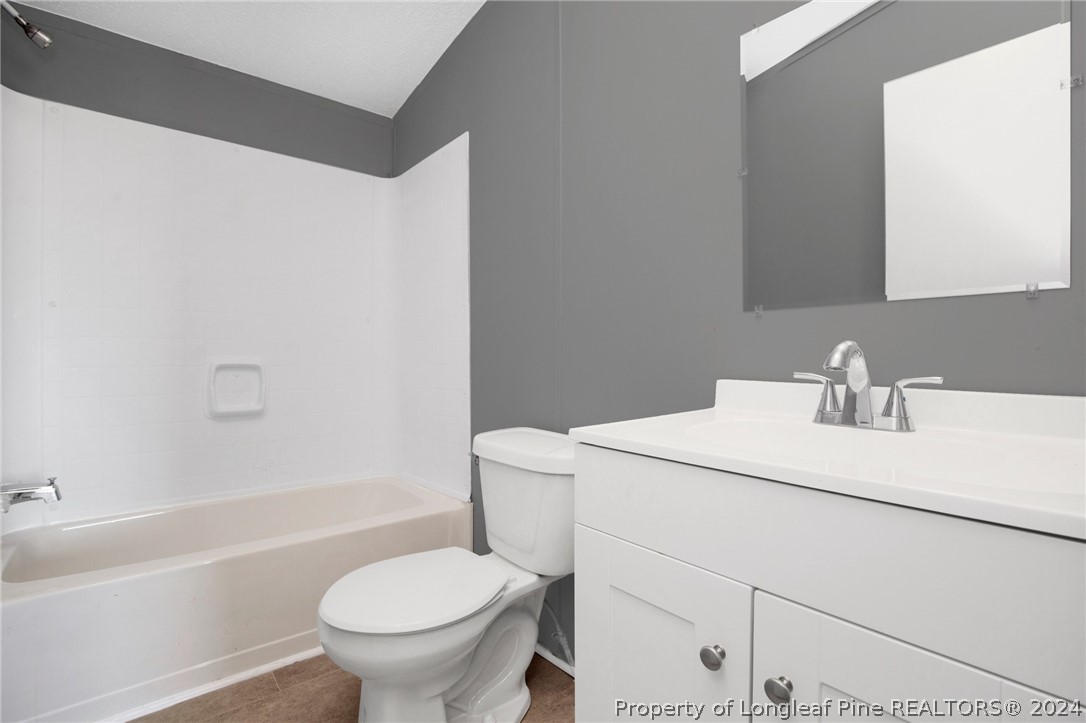 152 Three Bridges Road Rowland, NC 28383 - Photo 17 of 27 a bathroom with a sink a toilet and a bathtub