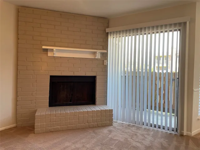 a living room with a fireplace and a window