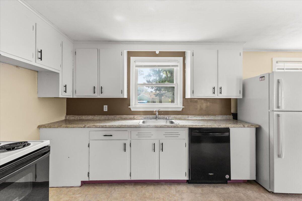 74 Fearing Street Buzzards Bay, MA 02532 - Photo 16 of 32 a kitchen with a stove a sink and a refrigerator