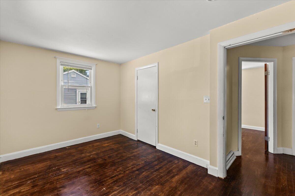 74 Fearing Street Buzzards Bay, MA 02532 - Photo 24 of 32 a view of an empty room with wooden floor and a window