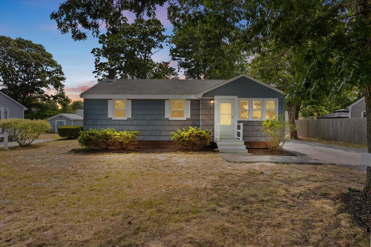 74 Fearing Street Buzzards Bay, MA 02532 - Photo 3 of 32 a front view of a house with a garden