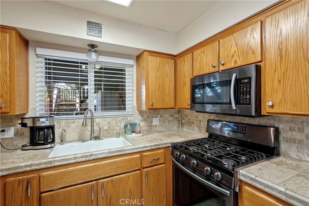 1747 Brighton Avenue Grover Beach, CA 93433 - Photo 11 of 50 a kitchen with a stove a sink and a microwave