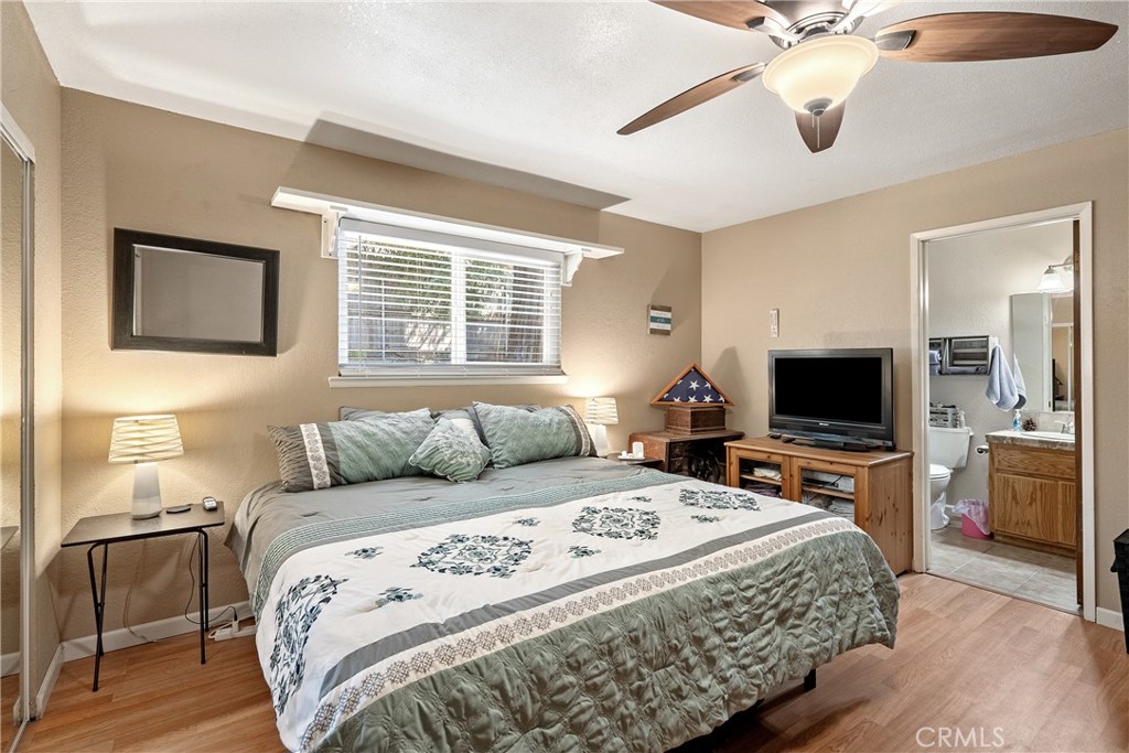 1747 Brighton Avenue Grover Beach, CA 93433 - Photo 14 of 50 a bedroom with a bed and wooden floor