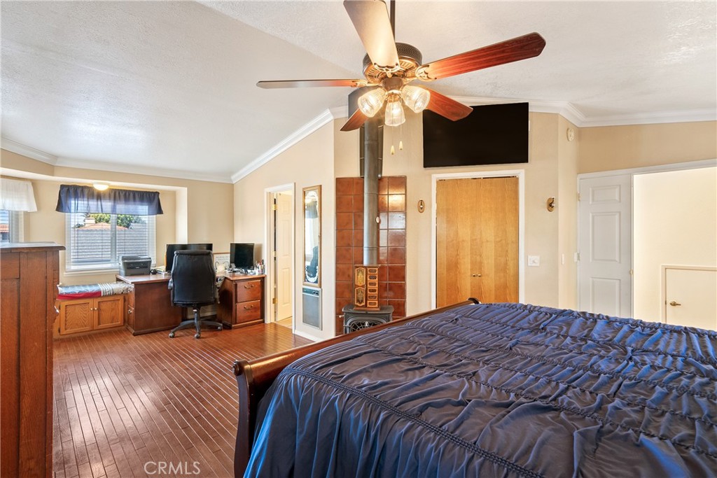 1747 Brighton Avenue Grover Beach, CA 93433 - Photo 24 of 50 a bedroom with a bed and a chandelier