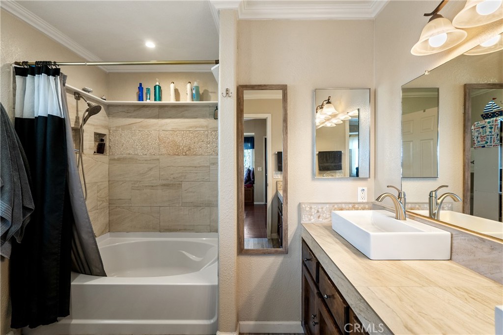 1747 Brighton Avenue Grover Beach, CA 93433 - Photo 26 of 50 a bathroom with a tub sink and a mirror