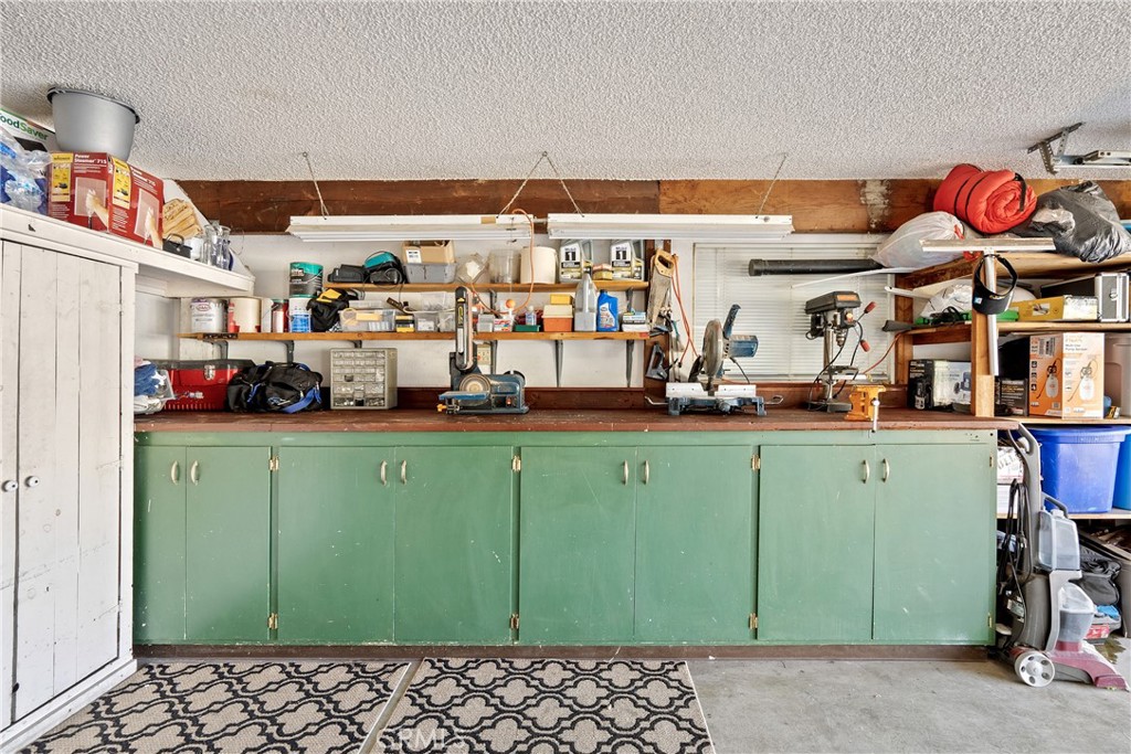 1747 Brighton Avenue Grover Beach, CA 93433 - Photo 32 of 50 a kitchen with lots of clutter and cabinets