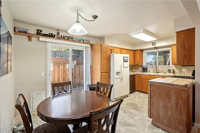 a kitchen with stainless steel appliances a refrigerator sink and cabinets