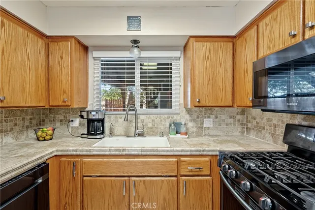 a kitchen with a stove a sink and a microwave